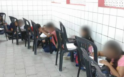 Alunos assistem ao primeiro dia de aula sentados no chão em Fortaleza